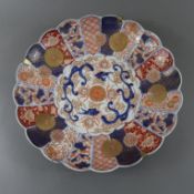 Imari-Platte - Japan, späte Meiji-Zeit, leicht gemuldete segmentförmig gerippte Rundform mit gewell