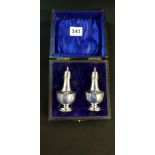 BOXED SET OF SOLID SILVER PEPPERETTES STANDING 3.5' IN ORIGINAL BOX. 62G BIRMINGHAM 1909 BY