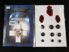 ROYAL ULSTER CONSTABULARY GEORGE CROSS PRESENTATION BROCHURE AND SELECTION OF RUC BADGES AND