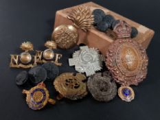 BOX OF ANTIQUE MILITARY HELMET PLATES, CAP BADGES AND BUTTONS