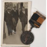 ORIGINAL BLACK AND TAN MEDAL ACCOMPANIED WITH PHOTO OF GENTLEMAN WEARING IT