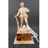 SMALL LUCITE FIGURE OF 'A GENTLEMAN IN KHARKI' WITH MINIATURE TAPE MEASURE IN THE BASE A/F