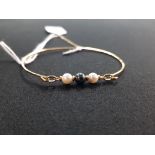 9 CARAT GOLD BRACELET & A PEARL BANGLE