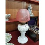 Milk glass oil lamp with cranberry shade