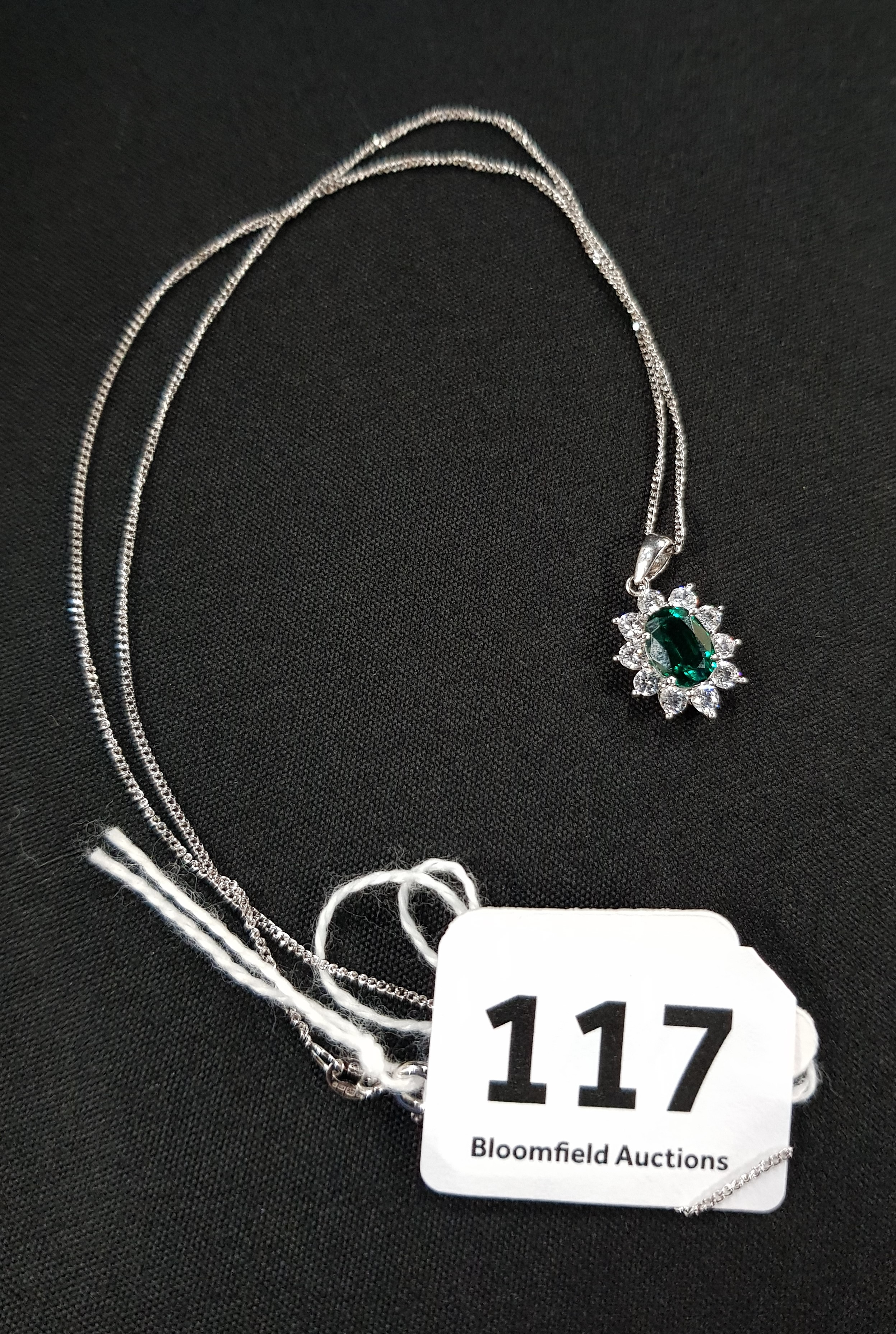 EMERALD AND DIAMOND PENDANT SET IN 9 CT WITH 9 CARAT CHAIN