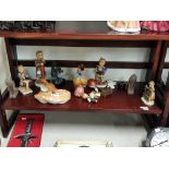 Shelf lot of various figures including Hummel