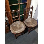 PAIR OF CHAIRS WITH ROUND SEATS FROM THE SUSSEX RANGE POSSIBLY DESIGNED BY FORD MADOX BROWN