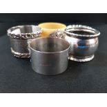 4 SILVER NAPKIN RINGS AND 1 OTHER WITH SILVER CREST