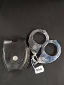 VERY RARE ROYAL ULSTER CONSTABULARY 1960 PATTERN HIATTS HANDCUFFS AND BLACK LEATHER POUCH