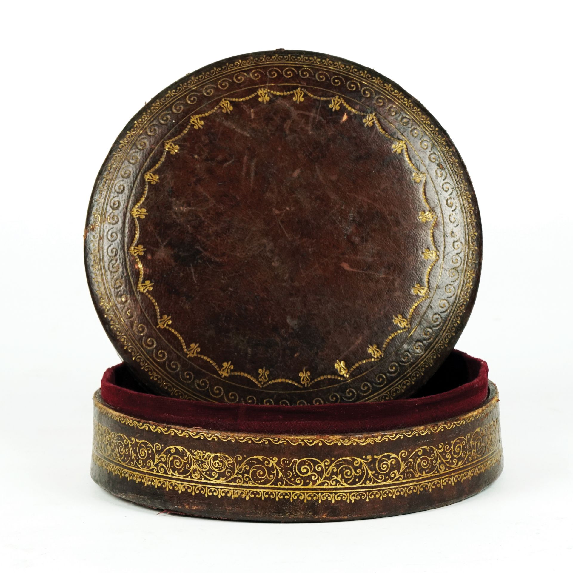 A leather round box, 19th century 17cm. diam.