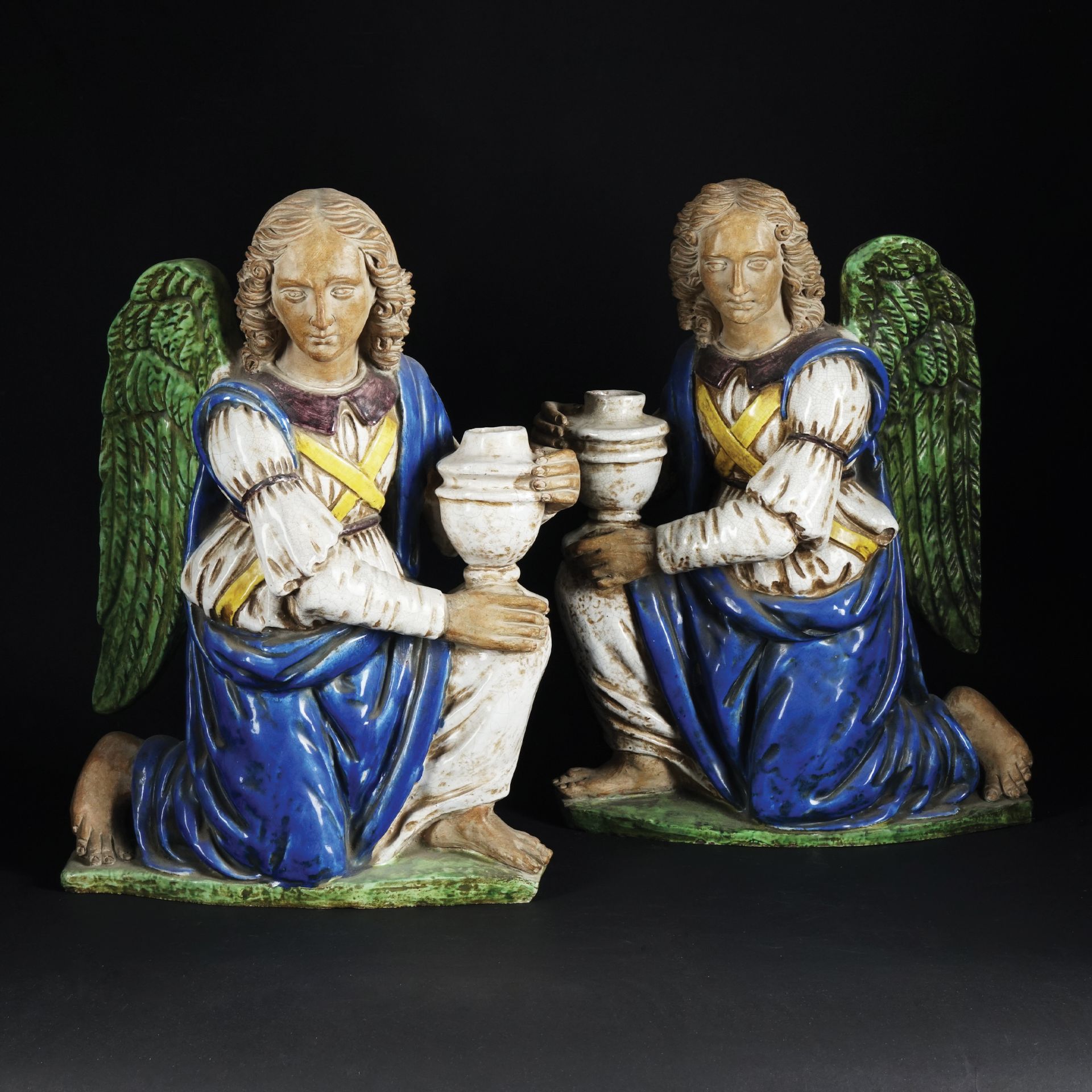 A pair of Florentine white and polychrome terracotta figures of a kneeling angel 48x34cm. (one