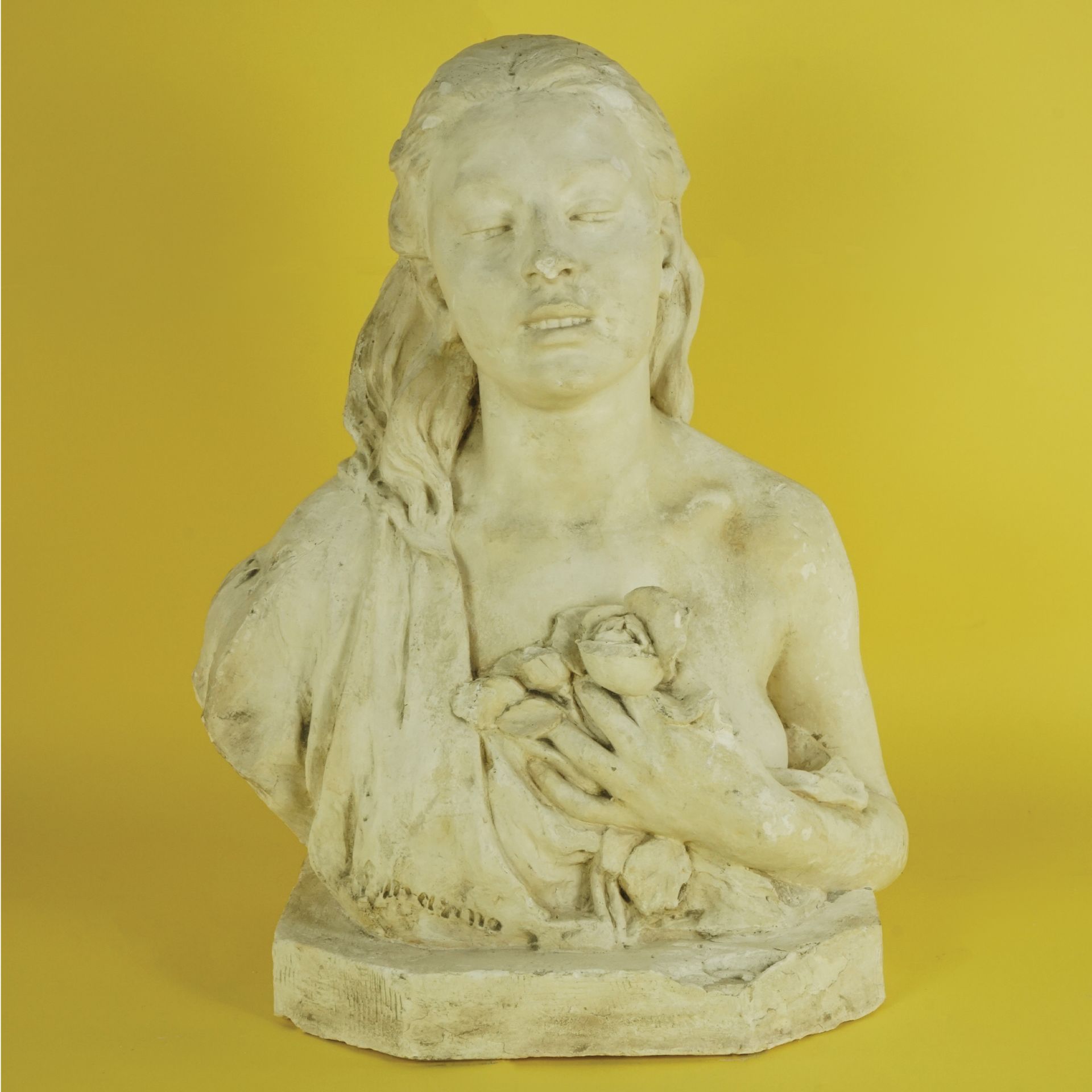 A plaster female bust with roses 61x47x28cm. (small lacks)