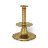 A mid-17th century and later brass trumpet-base candlestick, English, circa 1650-80