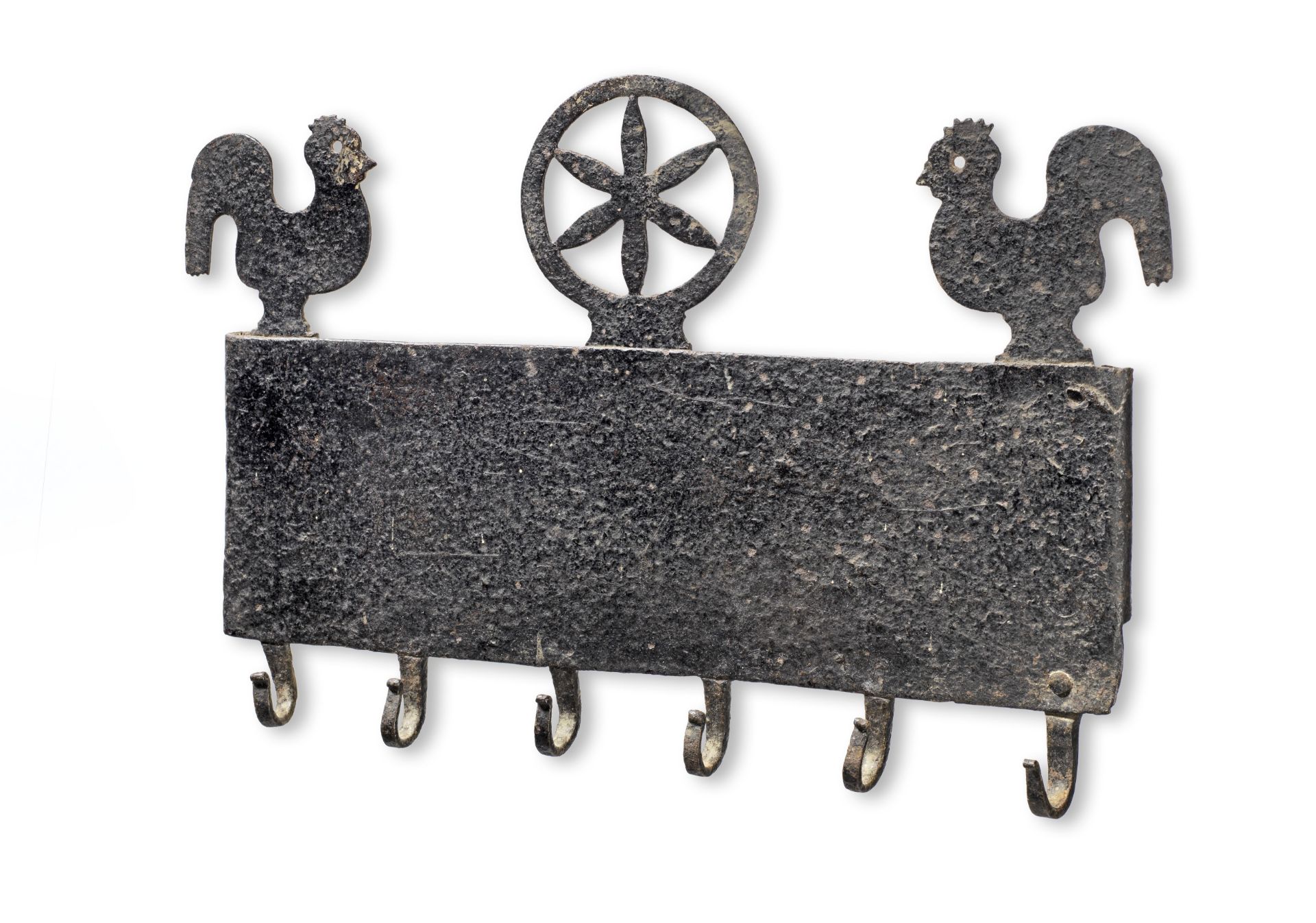 A black-painted iron mural utensil rack