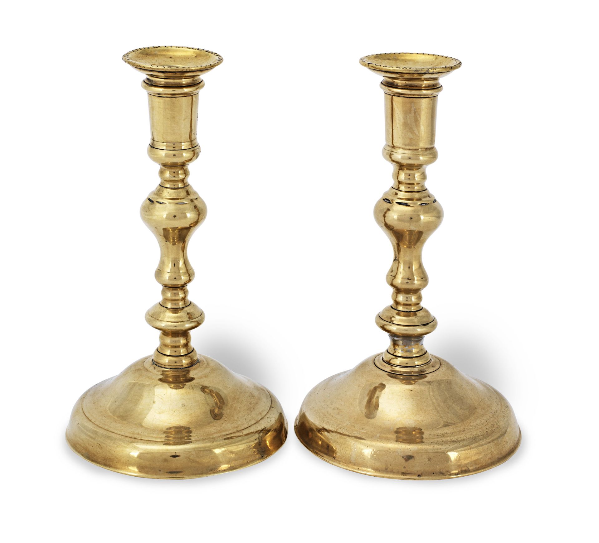 A pair of early to mid-18th century brass socket candlesticks, French/English, circa 1720 (4)