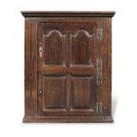 A George II joined and boarded oak and walnut crossbanded cupboard, probably Welsh, circa 1750