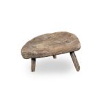 An ash primitive low stool, English/Welsh, circa 1800
