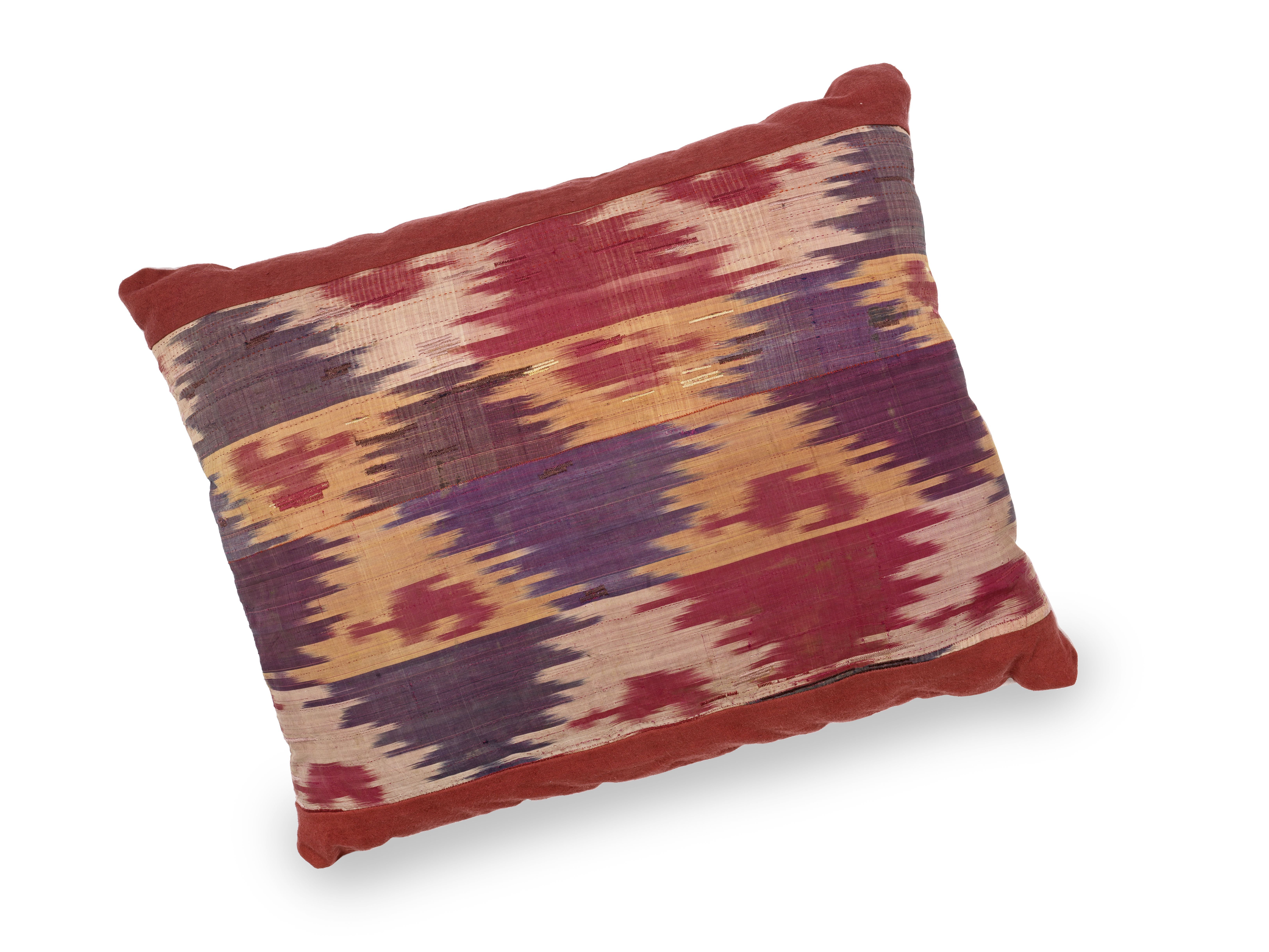 A large cushion made from 19th century silk Ikat and natural-dyed linen