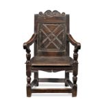 A Charles I joined oak panel-back open armchair, West Country, circa 1630