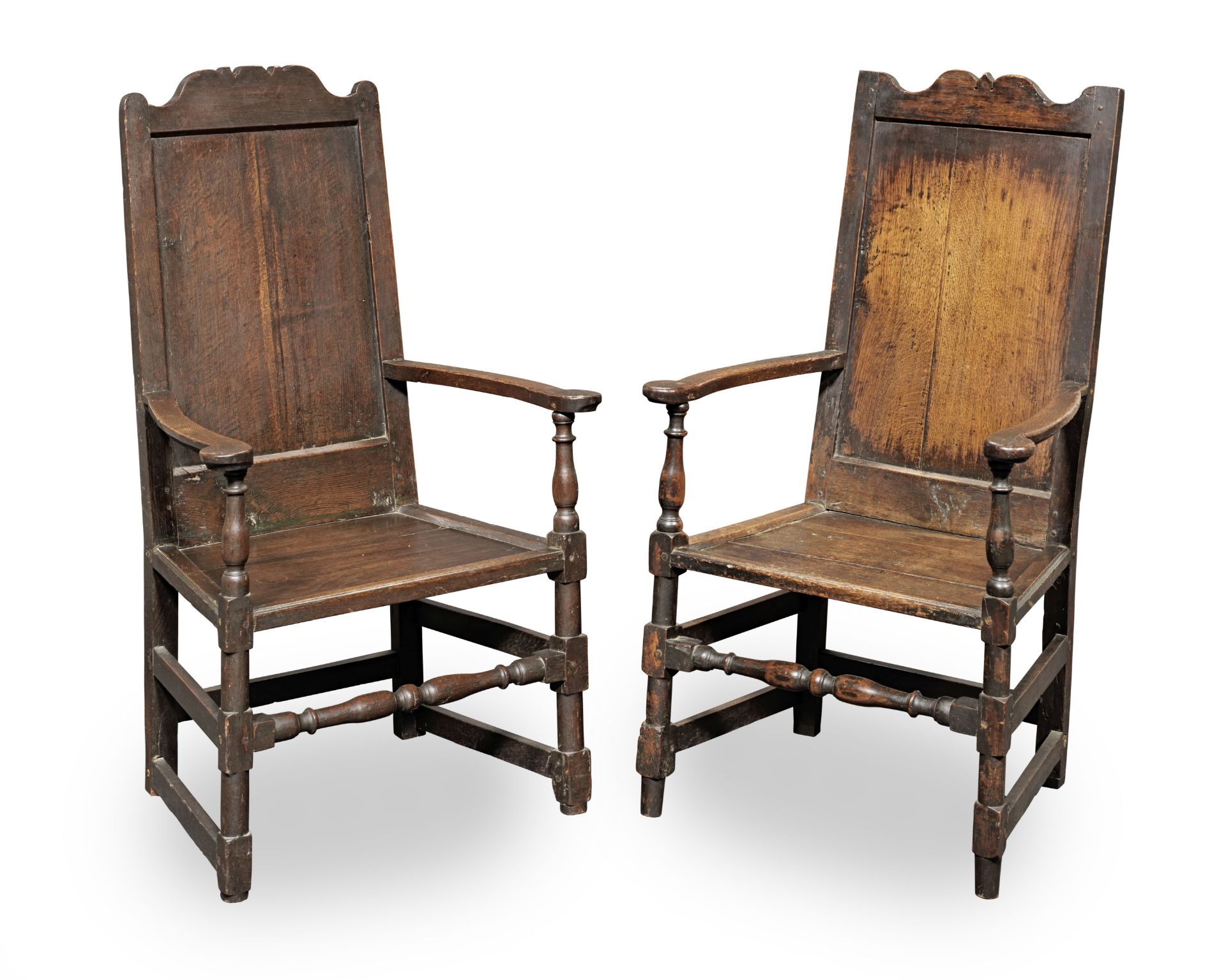 A near pair of Queen Anne joined oak panel-back open armchairs, circa 1710 (2)