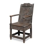 A Charles II oak panel-back armchair, circa 1670, with historic repairs,