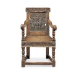 A Charles I joined oak panel-back open armchair, circa 1640 and later