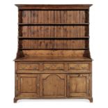 A rare and impressive George II solid yew-wood high dresser, Denbighshire, circa 1750