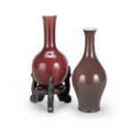 A 19th century Chinese sang de boeuf small bottle vase and an aubergine glazed vase,