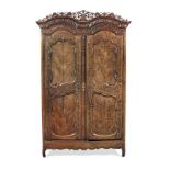 An impressive 18th century carved fruitwood armoire, French