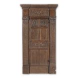 A 19th century Renaissance-Revival joined oak door and casing