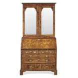 A George II figured walnut and featherbanded bureau cabinet, circa 1740