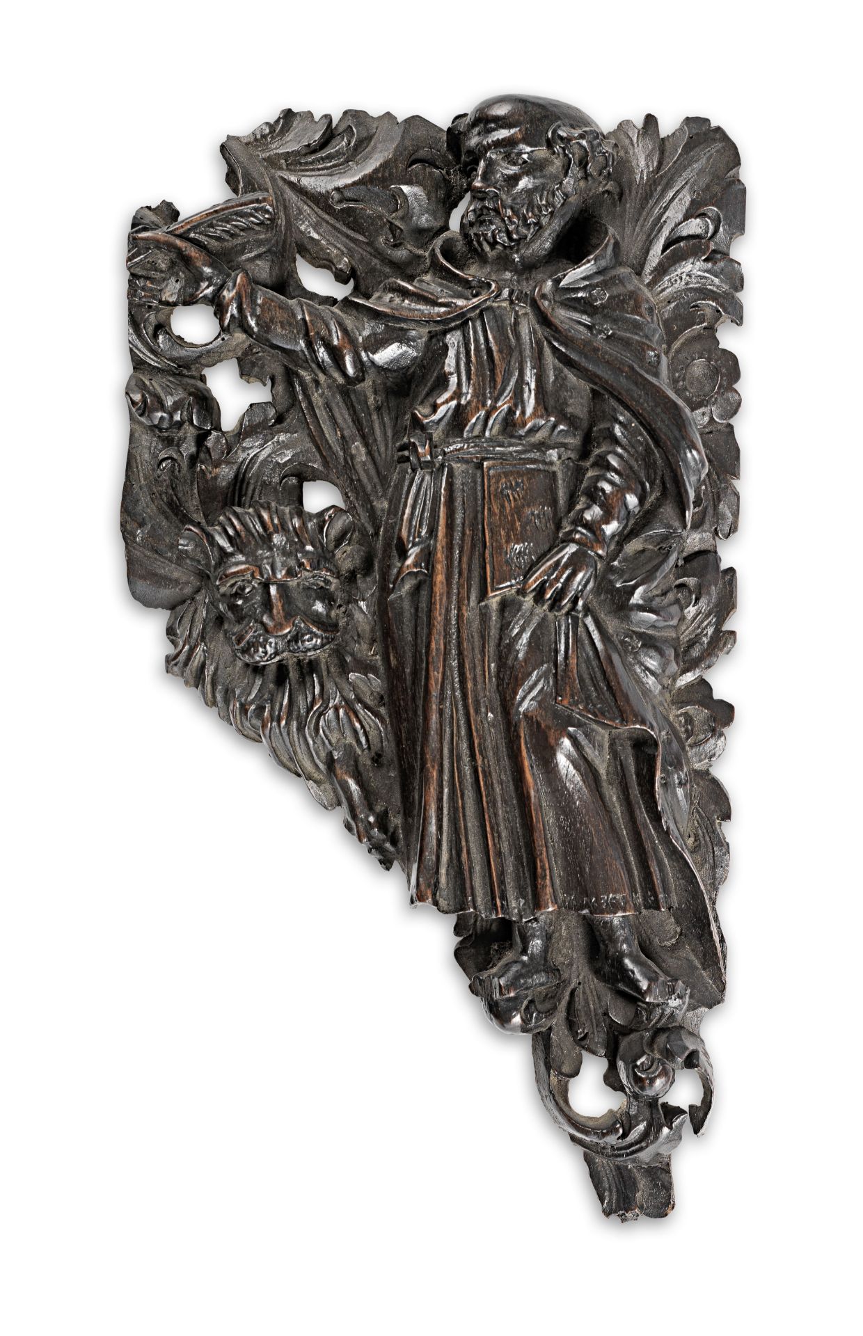 A 17th century carved walnut spandrel, St. Jerome and the Lion