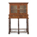 A William & Mary yew-wood cabinet-on-stand, circa 1690 and later