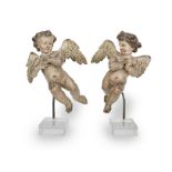 A small pair of 18th century polychrome-decorated carved limewood putti, South German/North Itali...