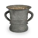 A large iron mortar, dated 1647, English or Dutch