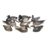 A group of nine polychrome-decorated wooden duck decoys, 20th century (9)