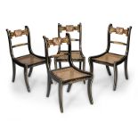 A set of four Regency/George IV 'ebonised', polychrome-painted and parcel-gilt dining chairs, cir...