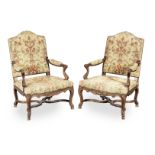 A pair of 19th century walnut and needlework upholstered open armchairs, French (2)
