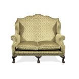 A George II style stained-beech and upholstered wing-back two-seater sofa