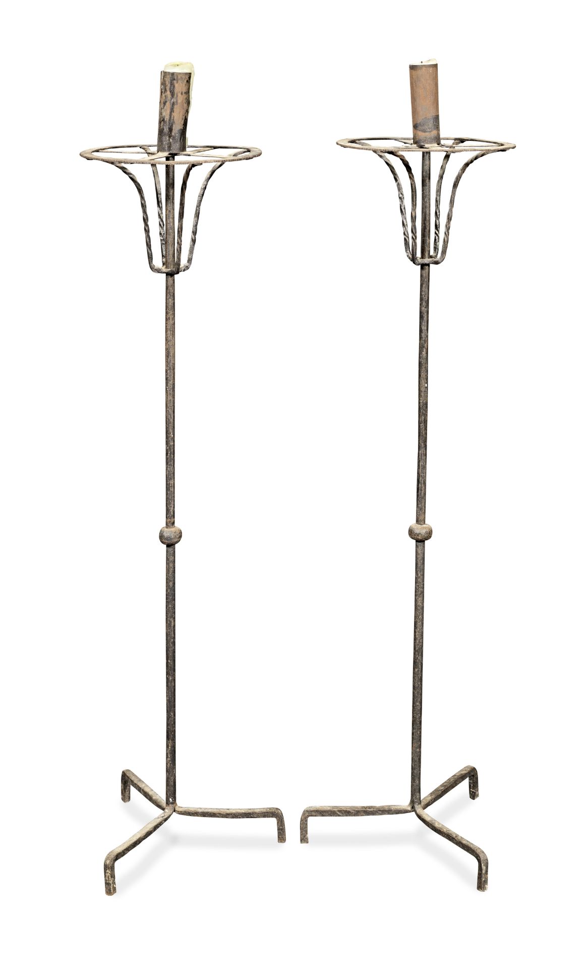 A pair of wrought iron floor standing candleholders (2)