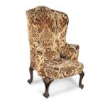 A George II walnut and upholstered wing-back armchair, circa 1740