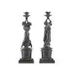 A pair of mid 19th century patinated bronze figural candlesticks (2)