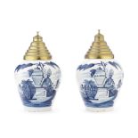 A pair of Dutch delft pottery tobacco jars with brass covers probably late 19th / early 20th cent...