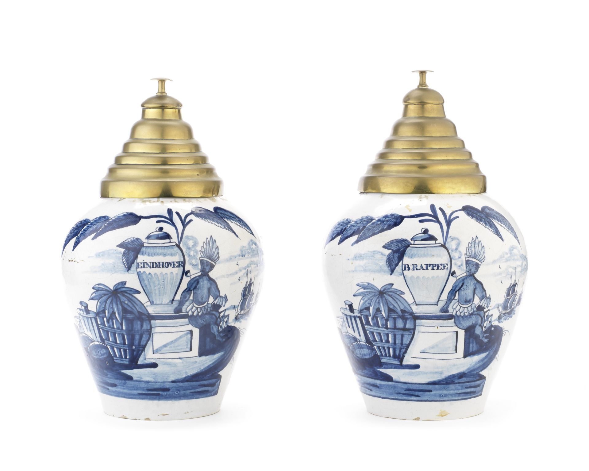 A pair of Dutch delft pottery tobacco jars with brass covers probably late 19th / early 20th cent...