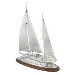 A spectacular and monumental silver model of a sailing yacht with London silver import marks for ...