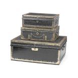 Three similar early 19th century brass mounted and studded black leather covered travelling trunk...