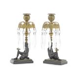 A pair of Regency gilt and patinated bronze figural lustre candlesticks in the Egyptian taste (2)