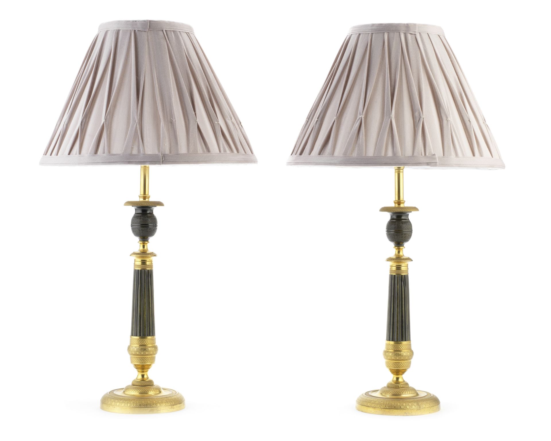 A pair of French Restauration patinated and gilt bronze candlesticks adapted as lamp bases (4)