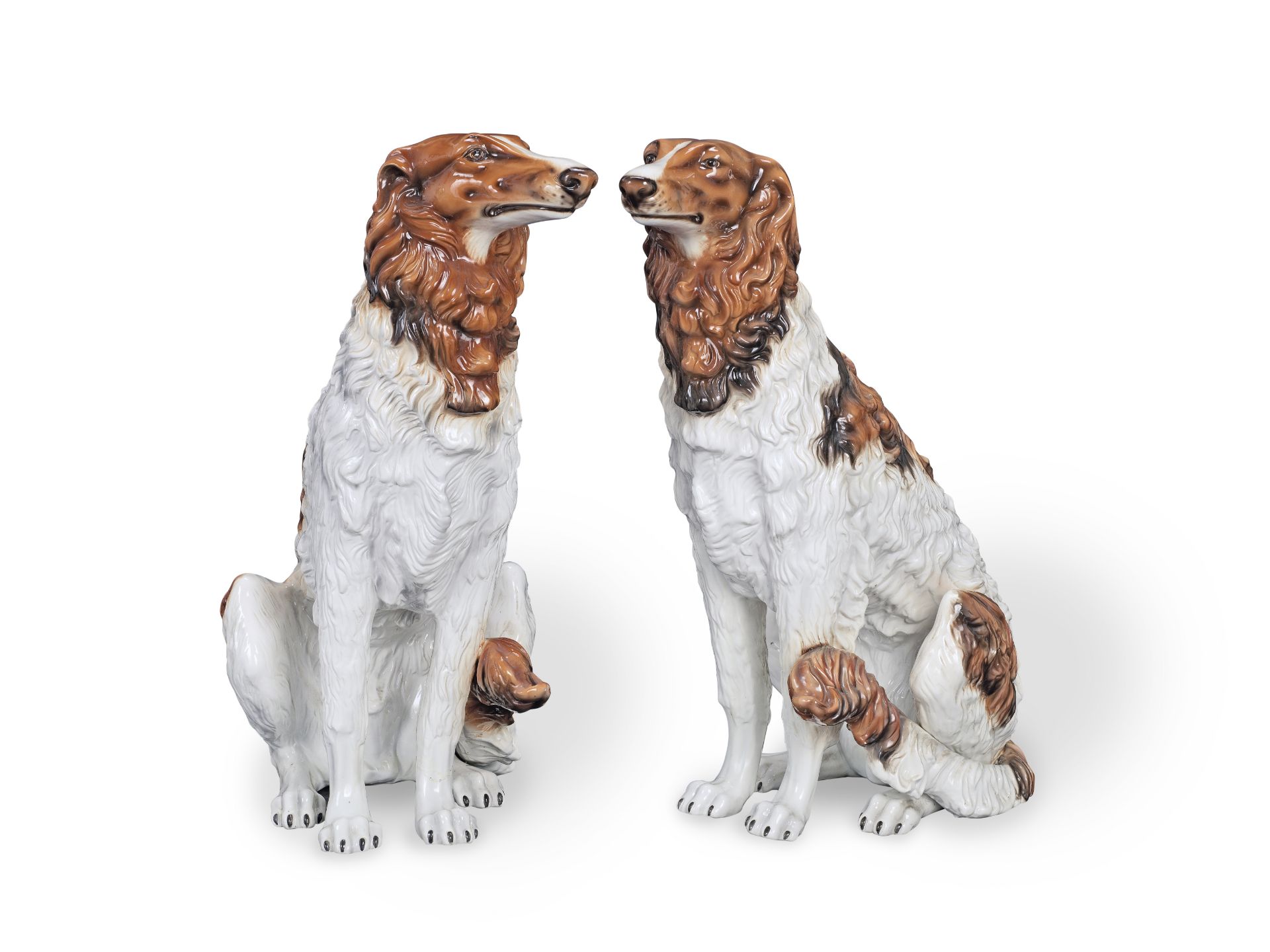 A pair of mid 20th century Continental ceramic models of seated hounds probably Italian (2)