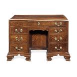 A George III mahogany and chequer inlaid serpentine kneehole combination writing/dressing table
